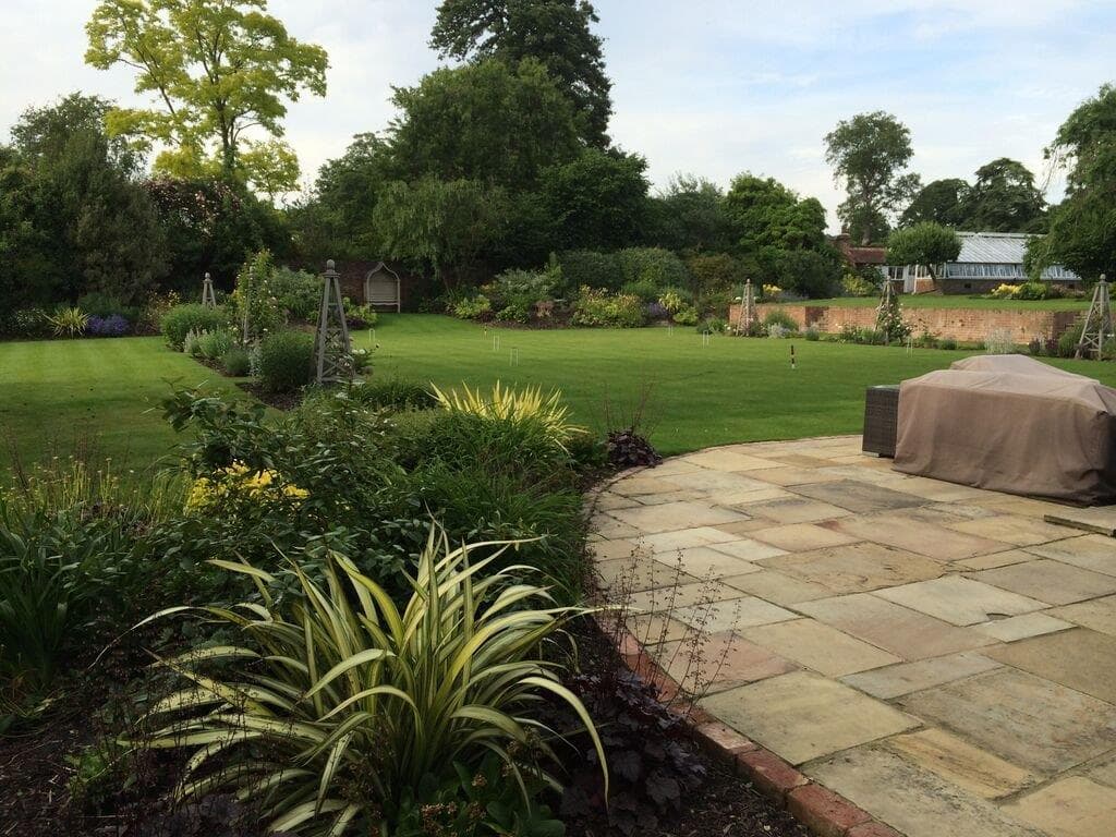 Low maintenance garden design with gravel, structured planting and minimal lawn